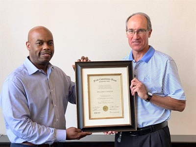 Dr. Keith Shah and Mike Crapps holding the award