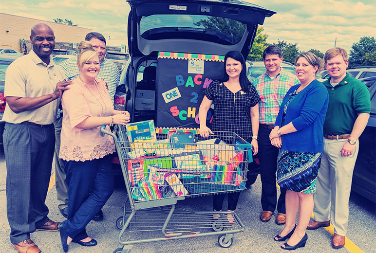 First Community Bank employees collecting school supply donations.